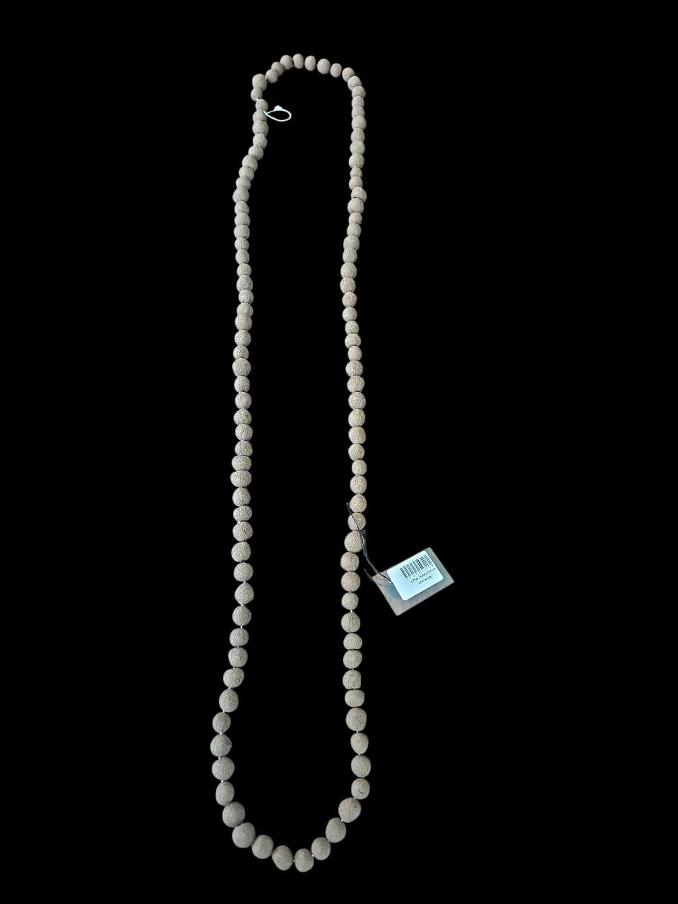 Necklace with a tag on a black background