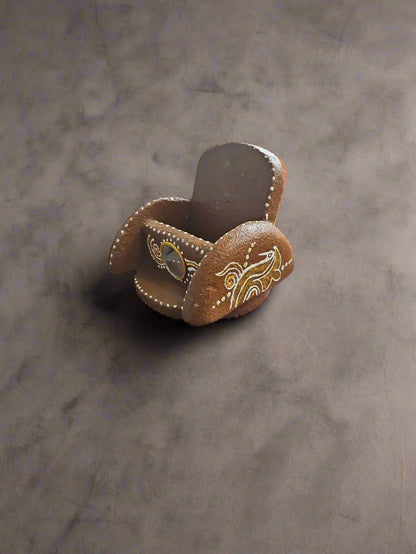 Decorative wooden item with intricate carvings on a black background