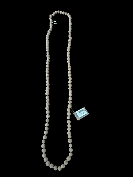 Necklace with a tag on a black background
